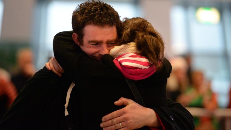 Home for Christmas: Joseph Callaghan is welcomed home from Canada by his wife Elaine  at Dublin Airport last year. Photograph: Dara Mac Dónaill / The Irish Times