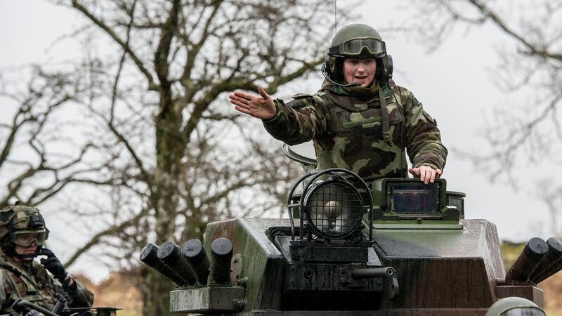 Cpl Denise Doyle (right) and Sgt Valerie Col on top of a mowag tank during a Mission Readiness Excercise in the Glen of Imall, Co Wicklow. Photograph: Brenda Fitzsimons