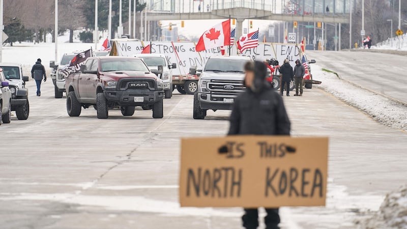 Protesters against Covid-19 restrictions  block the roadway leaving the Ambassador Bridge border crossing in  Ontario, Canada, on Tuesday.  Photograph:  Geoff Robins/AFP via Getty Images