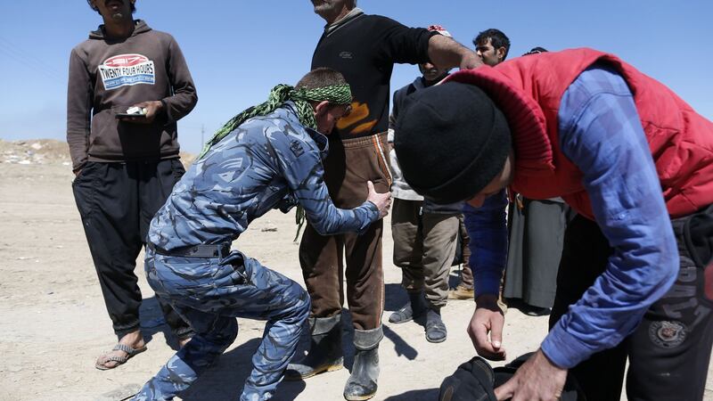 Displaced Iraqis, who fled their homes due to the ongoing fighting between government forces and Islamic State (IS) group fighters, are checked as they arrive on Saturday to be taken to camps as an ongoing operation against the jihadists continues in the city of Mosul.  Photograph: AFP/Getty Images