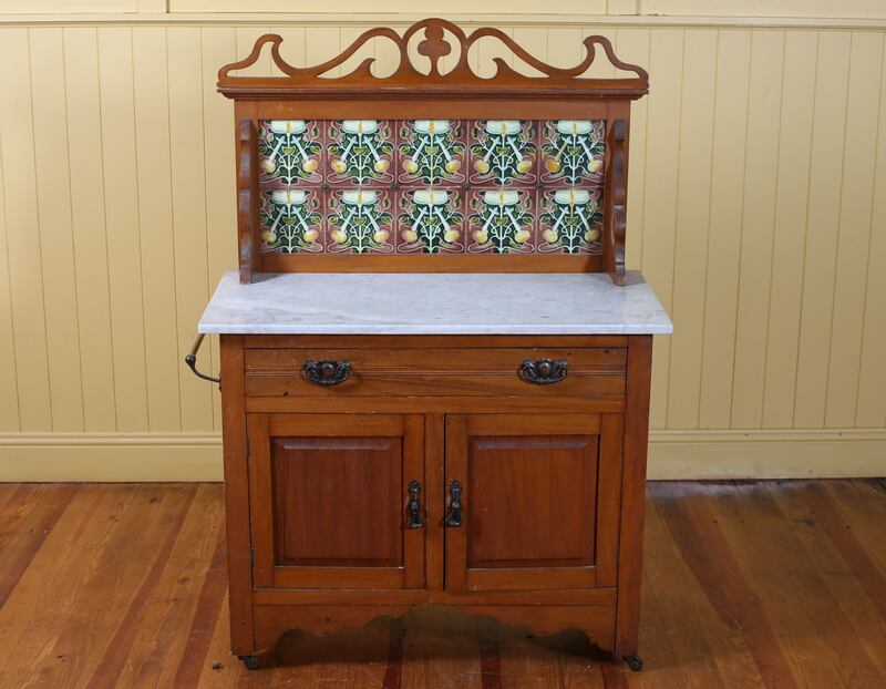An Edwardian wash stand with a marble top and tiles on the back (€300-€400), Mullen’s