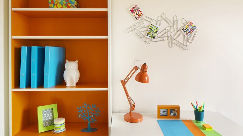 Spray paint a filing cabinet or shelf an uplifting orange to help make  the space feel welcoming.