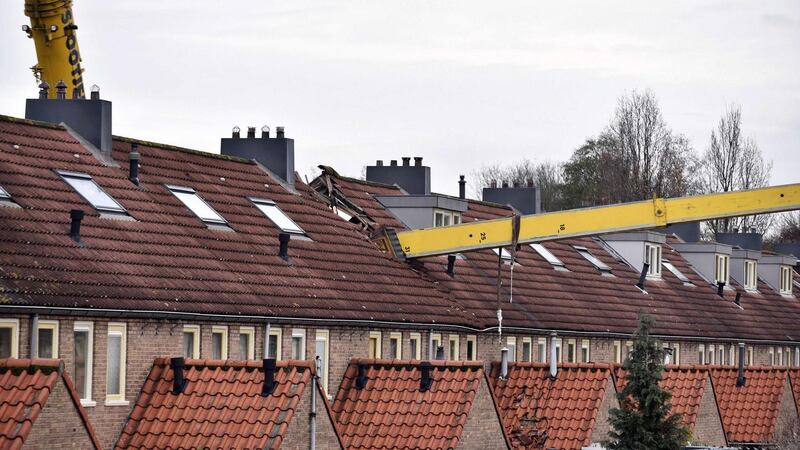 The incident occurred when a man tried to surprise his girlfriend by proposing from the top of the crane, which then toppled on to a house. Photograph: Michiel Van Beers/EPA