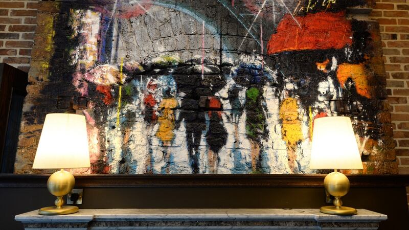 Artwork above one of two original fireplaces.