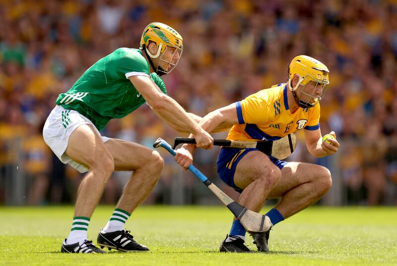 Limerick’s Dan Morrissey is unable to stop Mark Rodgers of Clare from scoring his side's opening goal. Photograph: James Crombie/Inpho