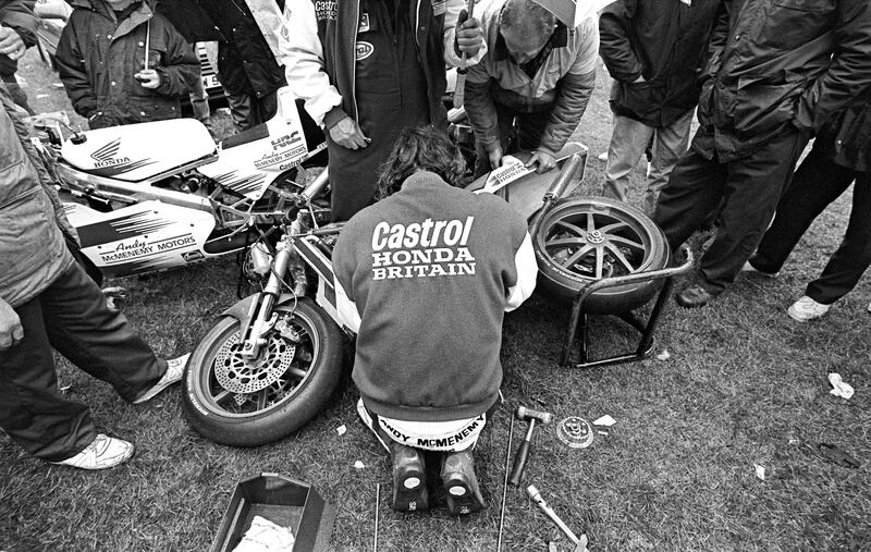 Having already won five world championships and fifteen Isle of Man TT races by the time this photograph was taken in the 1994 Tandragee 100 paddock, Joey Dunlop could have enjoyed the services of a full team of mechanics. Instead, as a skilled mechanic who had learned his craft by working on his own race bikes, Joey still preferred to prepare his own machinery.  Photograph: Stephen Davison
