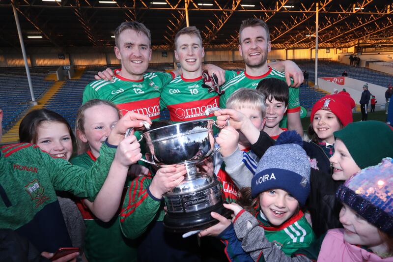 Young fans of of Loughmore-Castleiney lift the O’Dwyer cup with Noel, Brian and John McGrath after the Tipperary Senior Football Championship final in 2021. Photograph: Tom Maher/Inpho