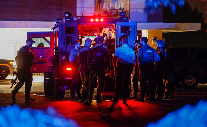 Law enforcement officers congregate outside an armoured vehicle in Raleigh after five people were shot and killed. Photograph: Travis Long/AP
