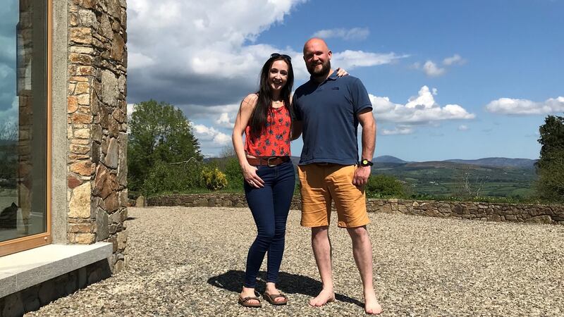 Eimear Malone and John Foley outside their house.