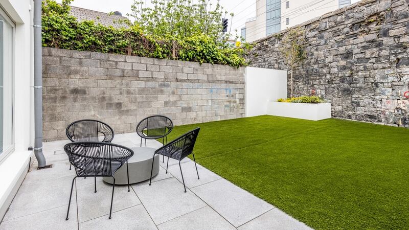 Garden with patio area in the foreground.