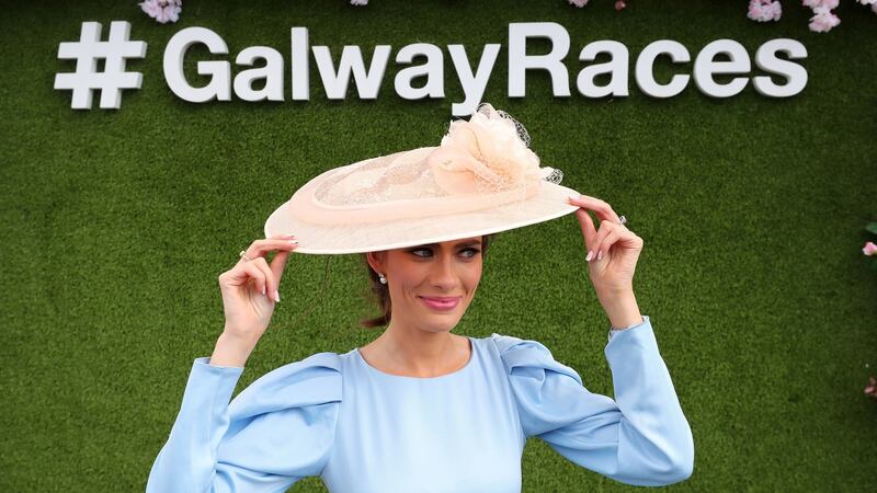 Catherine Furlong holds on to her hat in the wind during day three of the Galway Races Summer Festival 2021 at Galway Racecourse in Ireland. Photograph: Niall Carson/PA Wire