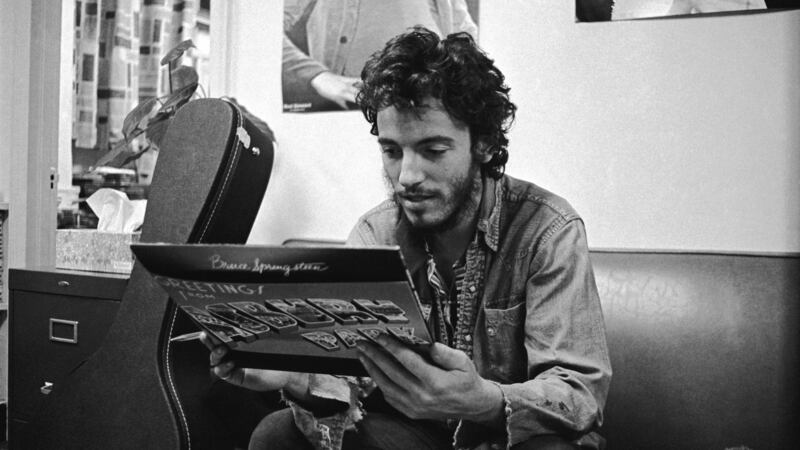 Bruce Springsteen in 1972, getting his first glimpse of his first album Greetings from Asbury Park, NJ