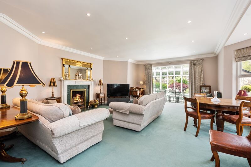 The elegant drawing room is on the right, with a marble fireplace and a large bay window looking out into the central courtyard.