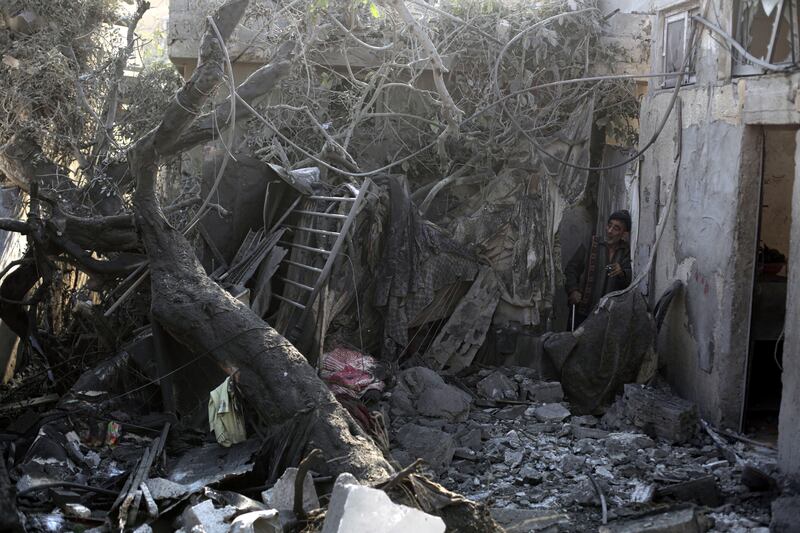 A man surveying the wreckage of a home in Khan Younis. Photograph: Yousef Masoud/The New York Times
                      
