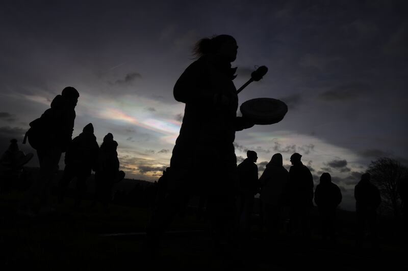 Visitors to Newgrange form a large circle chanting and enjoying the moments of sunrise on winter solstice morning. Photograph: Alan Betson