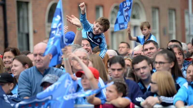 Fans throng Merrion Square to pay tribute to the All-Ireland-winning Dublin footballers. Photograph: Dara Mac Dónaill