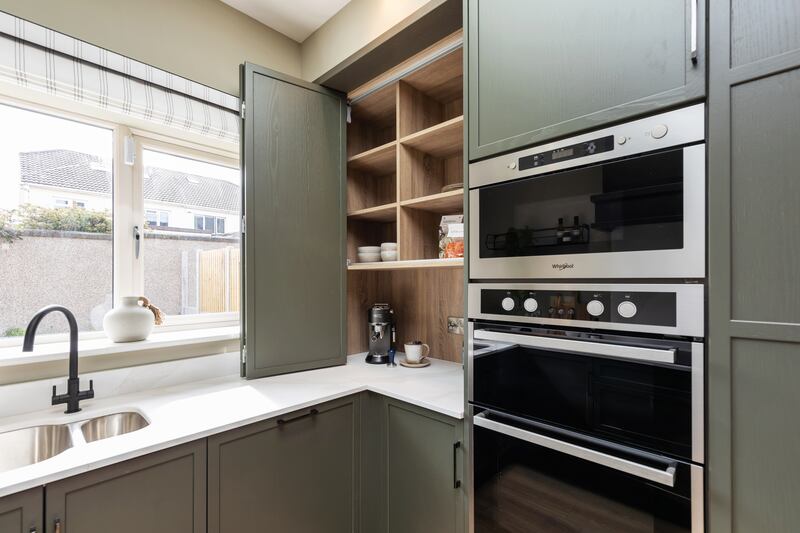 The contemporary kitchen/dining room has fully integrated appliances, including dishwasher, cooker and full-length larder fridge and freezer. 