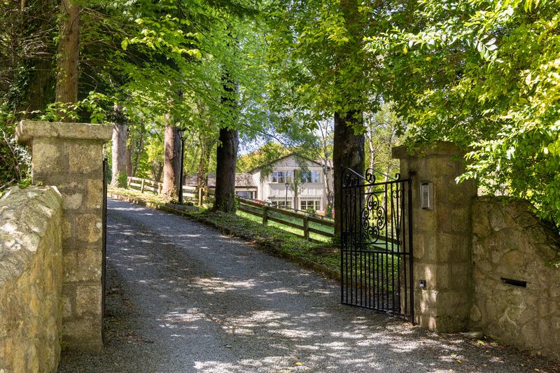 The house is set behind electric gates