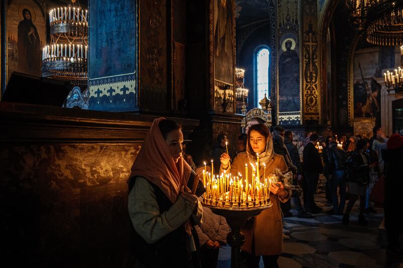 Worshippers light candles as they attend an Orthodox Easter service at Saint Volodymyr's Cathedral in Kyiv. Photograph: Dimitar Dilkoff/AFP