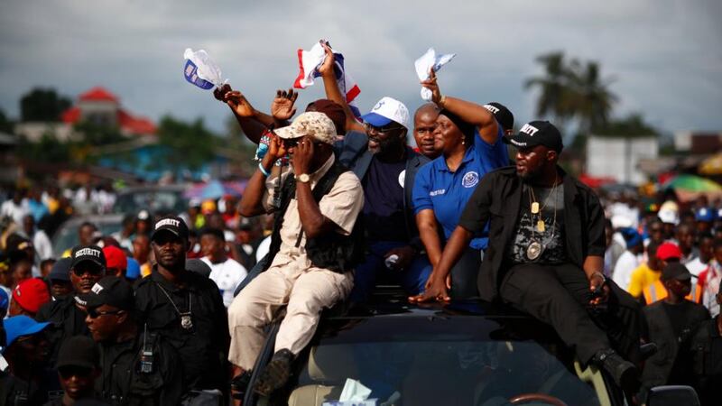 Liberian election: George Weah and Jewel Haward-Taylor wave to supporters. Photograph: Nic Bothma/EPA