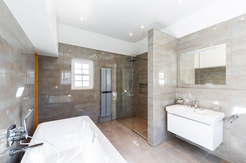 There are no en suites; instead, both bedrooms have access to a large Jack-and-Jill bathroom with a vast, standalone bath. The bathroom is large enough to be reconfigured into two en suites.