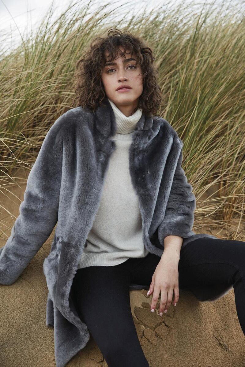 Merino sheepskin cocoon coat €1,294, cashmere roll neck jumper €194,velvet jeans €103