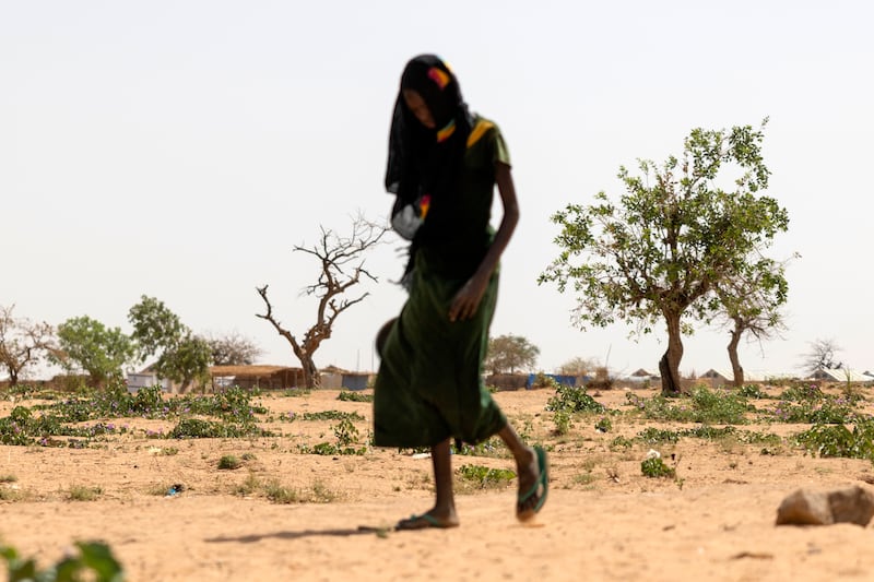 A malnourished child walks to dig for water in the desert outside the Farchana refugee camp in Chad. Photograph: Chris Maddaloni