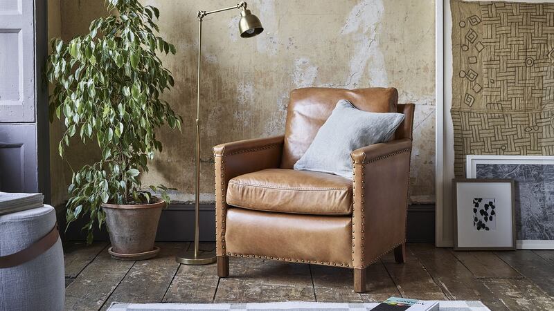 Cool and composed: Neptune’s Caspar tan armchair hand-stitched in the finest South American ox leather, price €2,120, with Sefton throw in cobble, €225 and Burford flat weave rug, price €660. See neptune.com for Irish stockists.