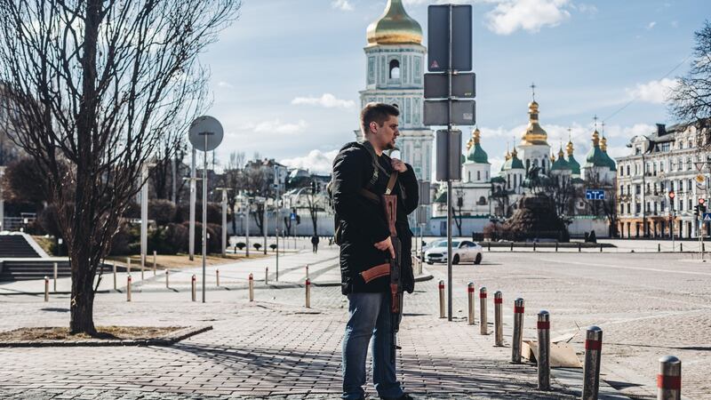 A civilian holds a Kalashnikov rifle   in Kyiv on Saturday: thousands have signed up to join Ukraine’s territorial defence force and taken weapons given out by the authorities. Photograph: Diego Herrera/Europa Press via Getty Images