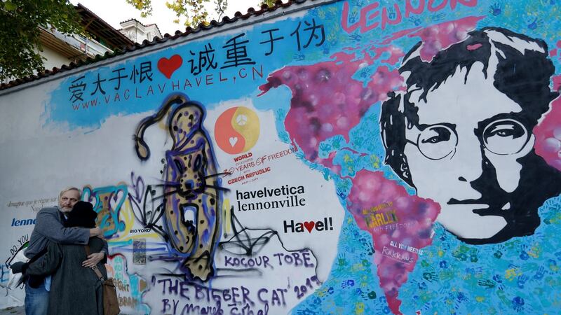A couple embrace beside the newly renovated and repainted ‘Lennon Wall’ in Prague on November 7th. The  Czech Republic is celebrating the 30th anniversary of the fall of the communism and the Velvet Revolution.  Photograph: Petr David Josek/AP