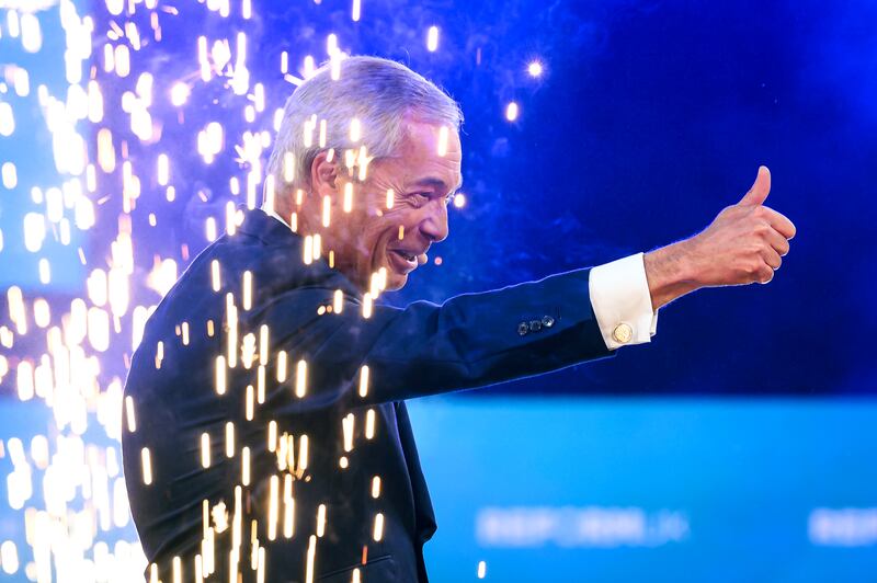 Nigel Farage gestures to supporters as he arrives on stage for his keynote address on day one of the Reform UK party conference. Photograph: Leon Neal/Getty Images