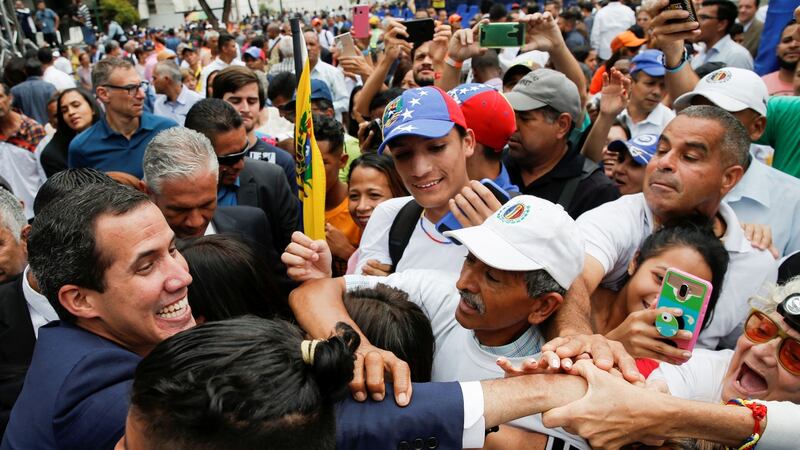 Venezuelan opposition leader Juan Guaido, who many nations have recognised as the country’s rightful interim ruler, greets supporters after a session of Venezuela’s National Assembly at a public square in Caracas on Tuesday. Photograph: Manaure Quintero/Reuters