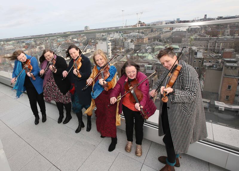 Clare Friel, Aisling Byrne, Róisín Harrigan, Mairéad Ní Mhaonaigh, Tara Conaghan and Denise Boyle from SíFiddlers at the launch of TradFest Temple Bar 2023 on the rooftop of Central Bank Plaza. Photograph: Mark Stedman