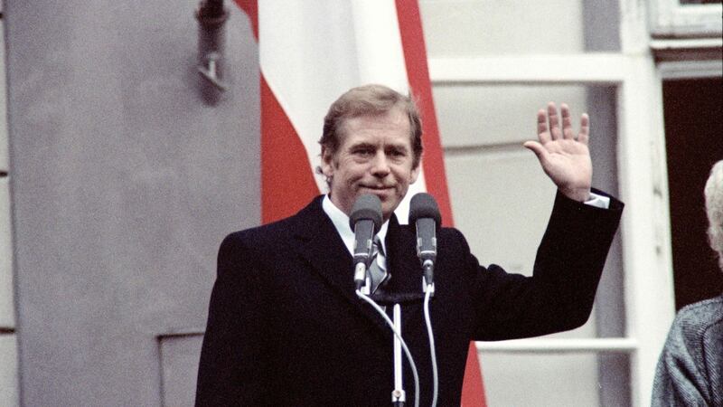 Newly elected Czechoslovak president Václav Havel waves to the crowd from the presidential palace balcony in Prague on December 29th, 1989. Photograph: Lubomir Kotek, Gerard FOUET/AFP via Getty Images
