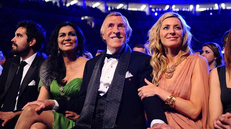 Bruce Forsyth with his wife Wilnelia (left) sitting with Tess Daly as he wins a Special Recognition award, at the 2011 National Television Awards. Photograph: Ian West/PA