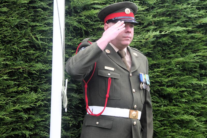 Sgt Andrew Kelly salutes at the unveiling of a memorial to his father, Pte Patrick Kelly, who was shot dead during the Troubles by the Provisional IRA