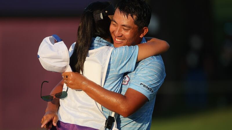 CT Pan of  Chinese Taipei celebrates  his win in the bronze medal playoff with his wife and caddie Yingchun Lin. Photograph:  Mike Ehrmann/Getty Images