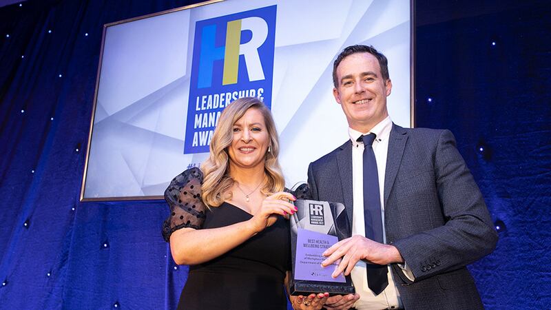 Sinead Joyce, marketing manager, DeCare Dental, presents the Best Health & Wellbeing Strategy award to Barry Mulligan, Department of Foreign Affairs.