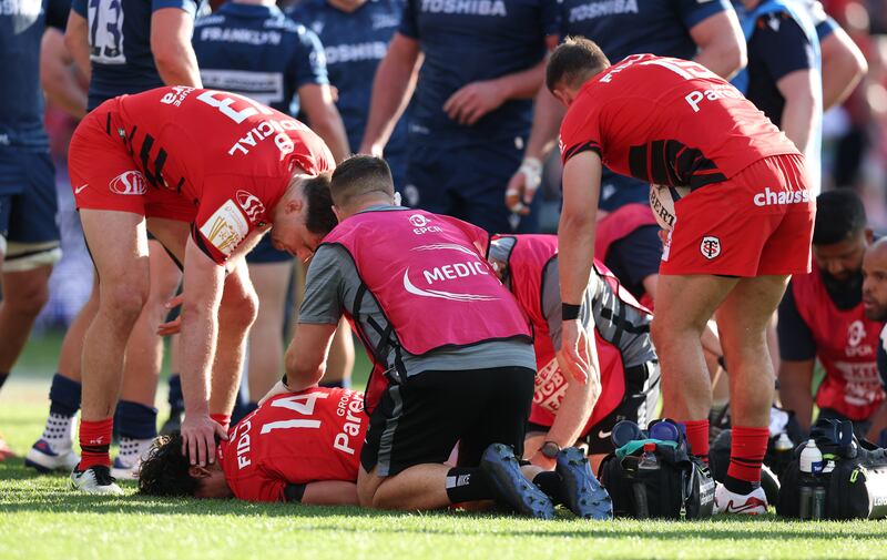 Ange Capuozo of Toulouse lies injured after scoring their fourth try. He was subsequently stretchered off during the Investec Champions Cup Round of 16 match against Sale Sharks at Stadium de Toulouse. Photograph: David Rogers/Getty Images