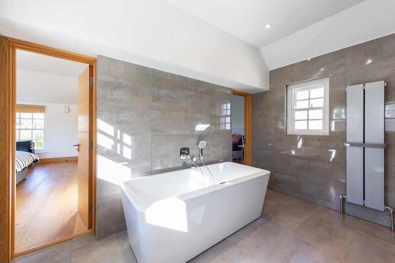 The standalone bath dominates the bathroom.