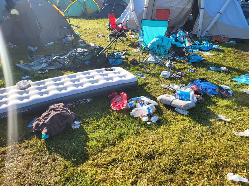 Despite a concerted effort by some, there still remains discarded items, including air beds and tents, and lots of beer cans littered on the ground. Photograph: Shauna Bowers
