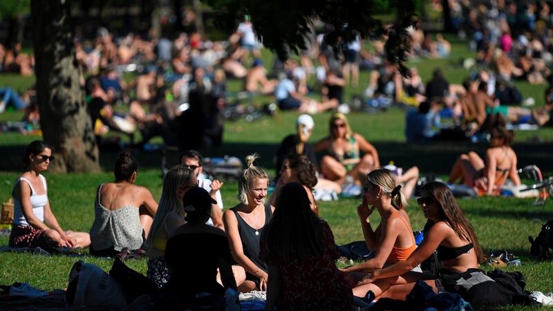 People enjoy the sunshine at Victoria Park in east London on Saturday, ahead of the coming into force of the first significant easing of Britain’s lockdown measures during the novel coronavirus COVID-19 pandemic on Monday. Photograph: AFP