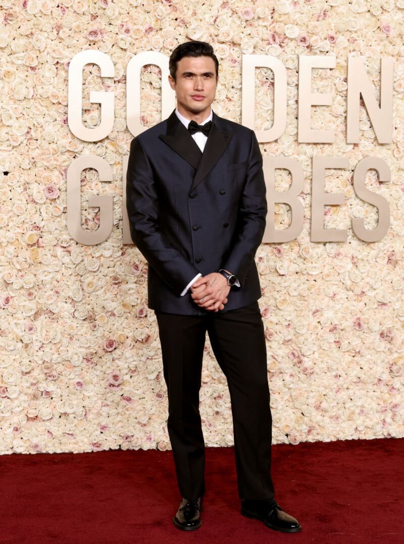 Charles Melton in a sharp, double-breasted Armani suit in navy blue. Photograph: Amy Sussman/Getty Images