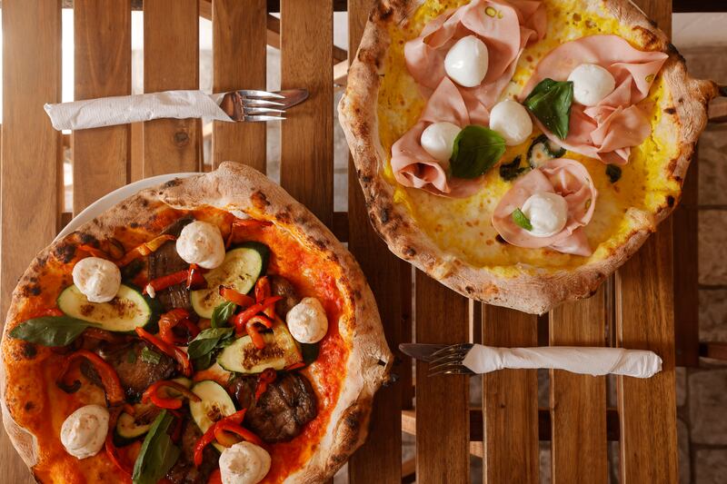 Veggie Gone Wild Pizza: roasted yellow datterini coulis, mozzarella fior di latte, Sicilian aubergines, courgettes, red peppers, sheep ricotta infused with courgette flowers and basil; and Pinco Pallino Pizza: roasted corn sauce base, mozzarella fior di latte, chicken mortadella, Cilento white figs, crusco dried pepper