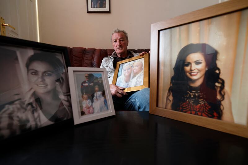 Harry Gilbert with framed photographs of Tara; Harry, Jodie and Kelsey; and Amanda, who took her own life following the fire. Photograph: Nick Bradshaw