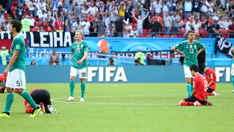 Germany’s Julian Brandt and Thomas Muller look dejected as South Korea players celebrate on the pitch after their 2018 World Cup Group F win. Photo: Michael Dalder/Reuters