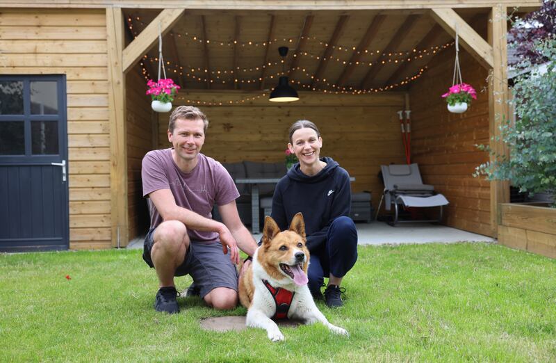 Marek Pisarczyk with his partner Beata and their 10-year-old rescue dog Rocky, at home in Donabate, Co Dublin. Photograph: Dara Mac Dónaill