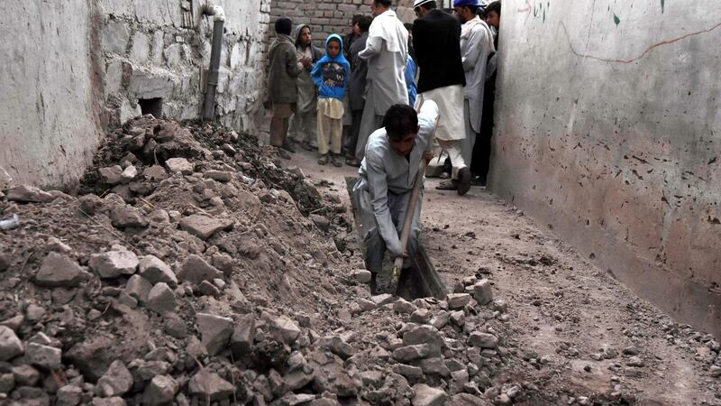 People remove debris from their damaged walls after a 7.5 magnitude earthquake, in Jalalabad, Afghanistan. Photograph: Ghulamullah Habibi/EPA
