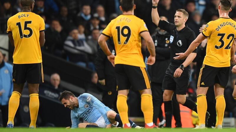 Willy Boly is shown a red card by referee Craig Pawson. Photo: Michael Regan/Getty Images