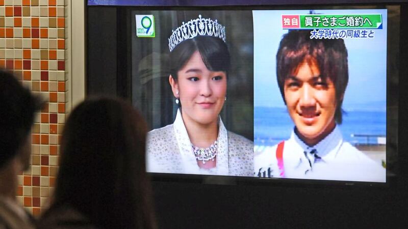 Royal wedding: passersby in Tokyo watch a report that Princess Mako, the granddaughter of Japan’s emperor, is to marry Kei Komuro. Photograph: Hitoshi Takano/Kyodo News via AP